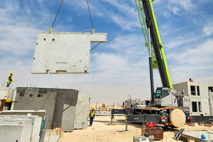 Crane lifting a precast concrete wall panel